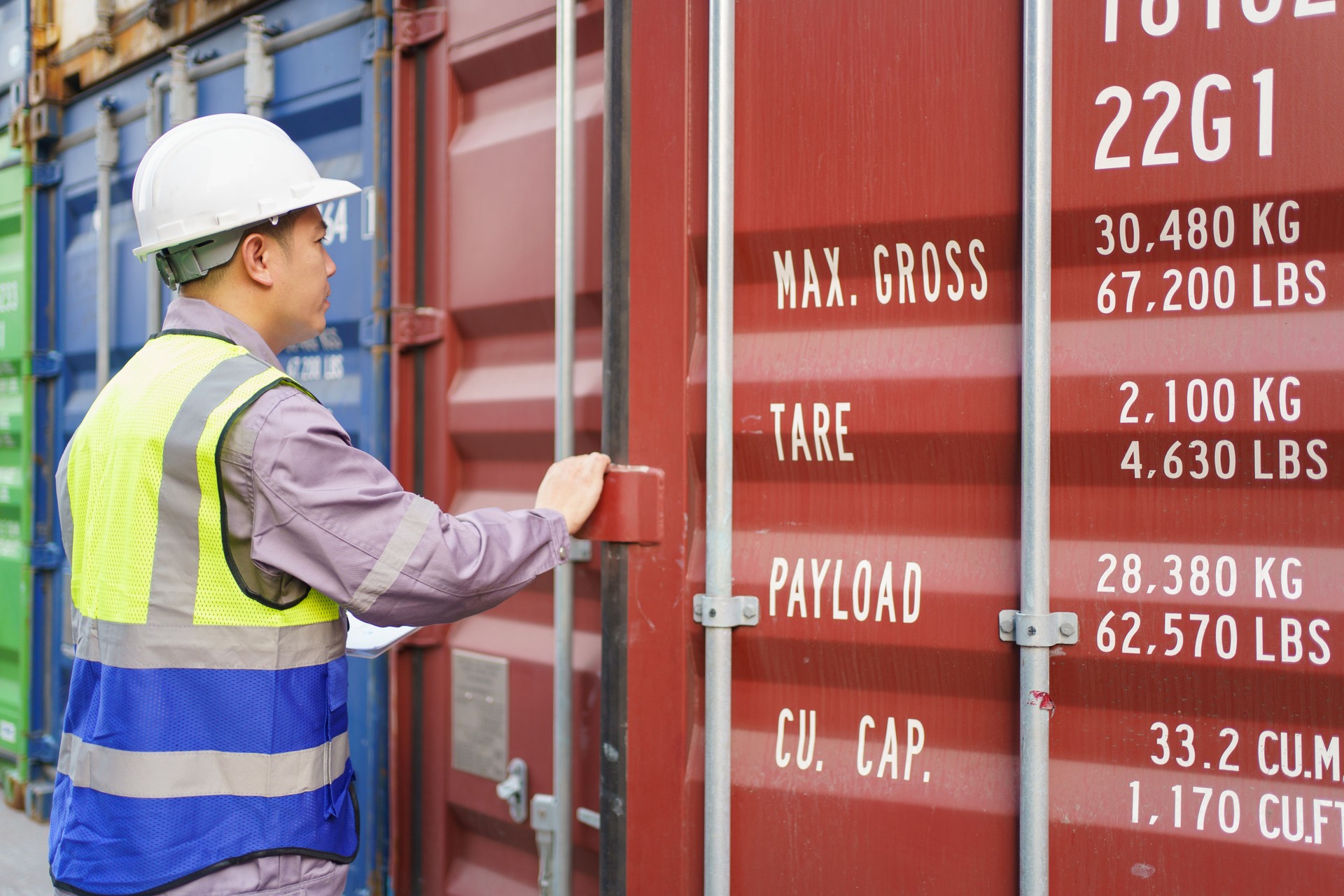 Customs clearance officer or shipyard engineer is inspects against the import - export cargo containers.